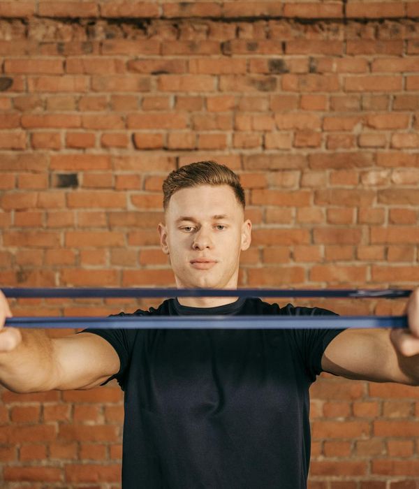 Focused man in a foundational strength pose improving his flexibility.